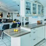 Kitchen with dining area and living room in the background.
