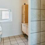 Bathroom with toilet, sink, and shower.