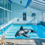 Indoor pool with orca float and seating