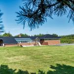 House with large garden and playground under blue sky