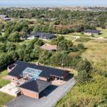 Modern house with pool and large garden in rural setting.