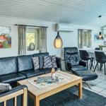 Living and dining area with sofa, dining table, and kitchen.