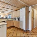 Kitchen with wooden ceiling, refrigerator, and work surface