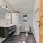 Bathroom with washing machine, toilet, and mirror