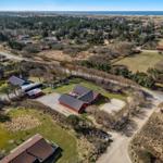 Red houses with garden and beach in the background.