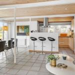 Open living and dining area with kitchen island and seating.