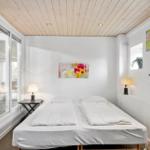 Bedroom with double bed, glass doors, and wall art