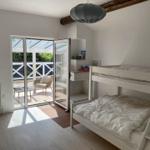 Zimmer mit Doppelstockbett und Terrassenzugang