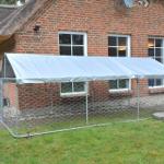 Hütte mit Metallzelt und Drahtzaun im Garten