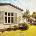 House with garden, windows with shutters and air conditioner