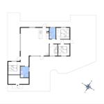 Apartment with three bedrooms, kitchen, and two bathrooms. Floor plan with compass.