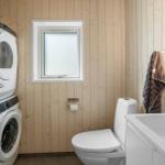 Bathroom with toilet, sink, and washing machine