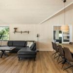 Living and dining area with sofa, dining table, and hardwood floor.