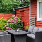 Red wooden outdoor area with seating and flowers