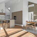 Kitchen with dining area, wooden floor, and modern furnishings.