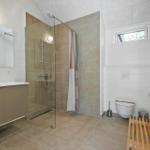 Bathroom with shower, sink, and toilet.