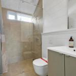 Bathroom with shower, toilet, and sink.