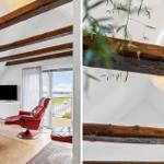 Wohnzimmer mit rotem Sessel, Holzbalken und Blick auf den Außenbereich.