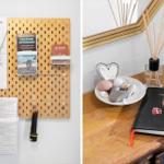 Wandorganizer mit Broschüren und Schlüssel. Holztisch mit Steinchen, Duft und Gästebuch.