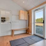 Entrance with wooden bench, coat rack, and view of river.
