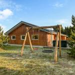 Wooden cabin with playground and hot tub in the garden