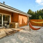 House with terrace, sandy area, and two hammocks.