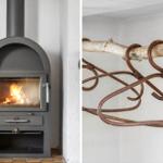 Holzofen mit Flamme und rustikale Metallkonstruktion an Wand