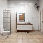 Bathroom with toilet, sink, and shower made of glass blocks.