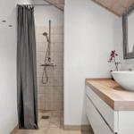 Bathroom with shower, sink, and mirror