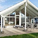 Patio with seating area and glass front to interior