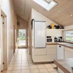Kitchen with wooden wall, refrigerator, and window
