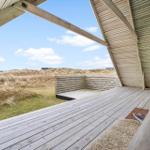 Holzterrasse mit Sitzbank und Blick auf Dünenlandschaft