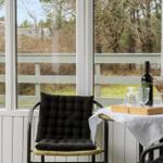Terrace with chair, table, and wine bottle by window