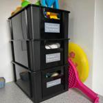 Black boxes with toys for sandbox, king es game, and pétanque.