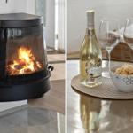 Wohnzimmer mit Kamin und Tisch mit Weißwein, Gläsern und Chips.