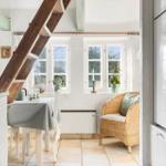 Küche mit Essbereich und Holztreppe zur oberen Etage.