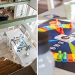 Esszimmer mit Tisch und Stühlen. Spielbrett mit Figuren und Karten auf Tisch.