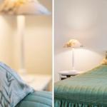 Schlafzimmer mit Bett, Nachttisch und Stehlampe mit floraler Schirmabdeckung.