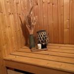 Wooden bench in sauna with vases and aroma candles