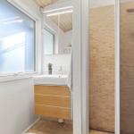 Bathroom with shower, sink, and window