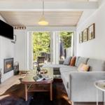 Living room with sofa, fireplace, and balcony view