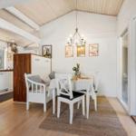 Dining room with table, chairs, and view to the terrace.