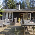 House with terrace, garden furniture, and grill area in the woods