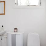 Bathroom with sink, mirror, and toilet.