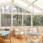Sunroom with seating and view of the garden.
