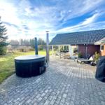House with terrace, hot tub, and garden.