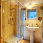 Bath with shower, sink and mirror