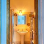 Bathroom with sink, shower, and mirror