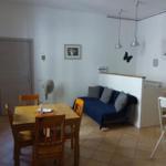 Living area with dining table, sofa, and kitchenette