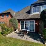 Der Blick aus dem vorderen Garten auf Terrasse und Wohnung